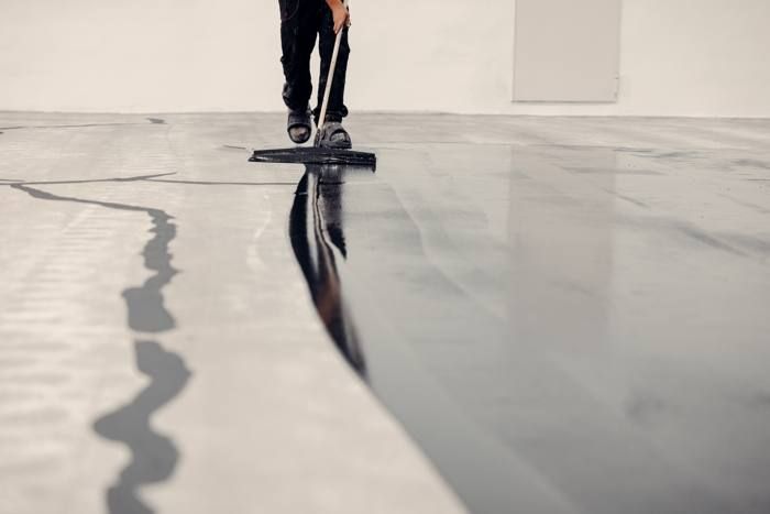 Spreading basecoat across the floor