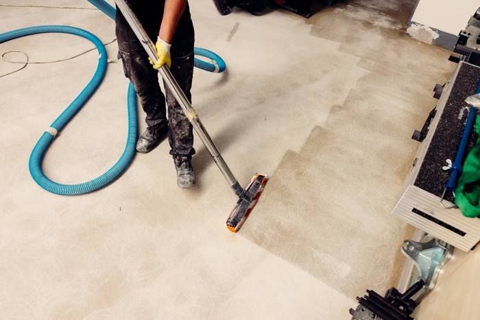 Vacuuming a ground concrete floor